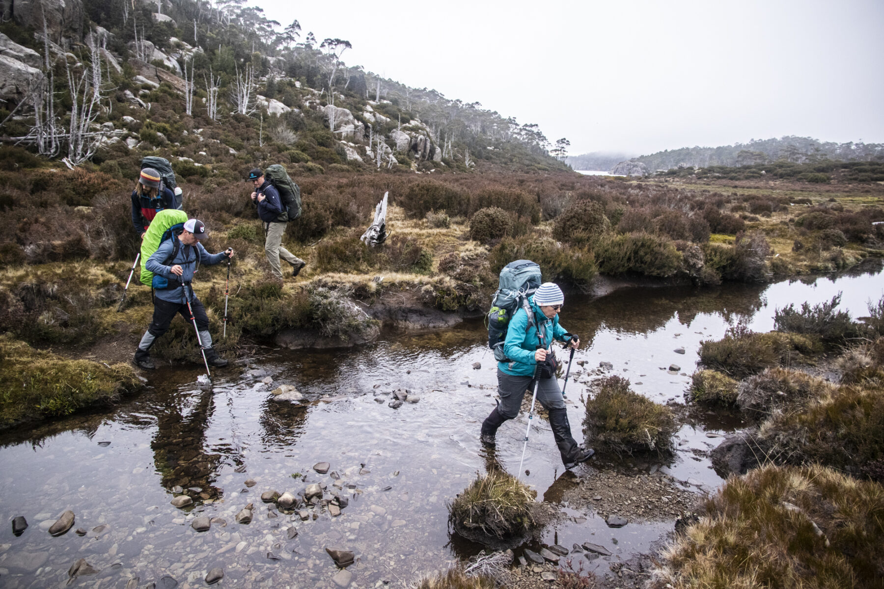 Hikers crossing a river on the Walls of Jerusalem