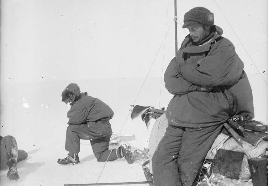 Sir Douglas Mawson resting on the side of a sledge