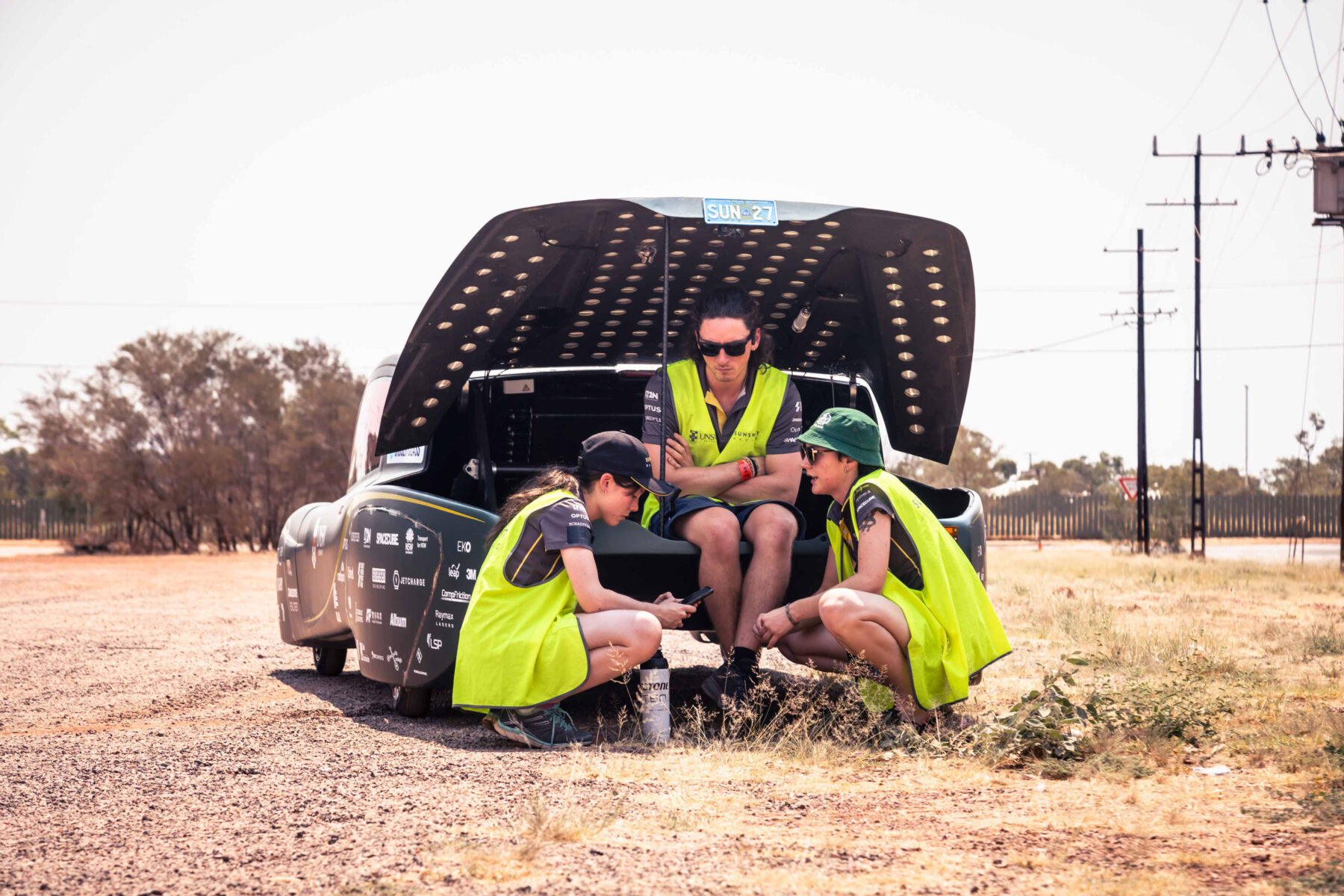 Members of the UNSW team rest for a few minutes at the Alice Springs checkpoint