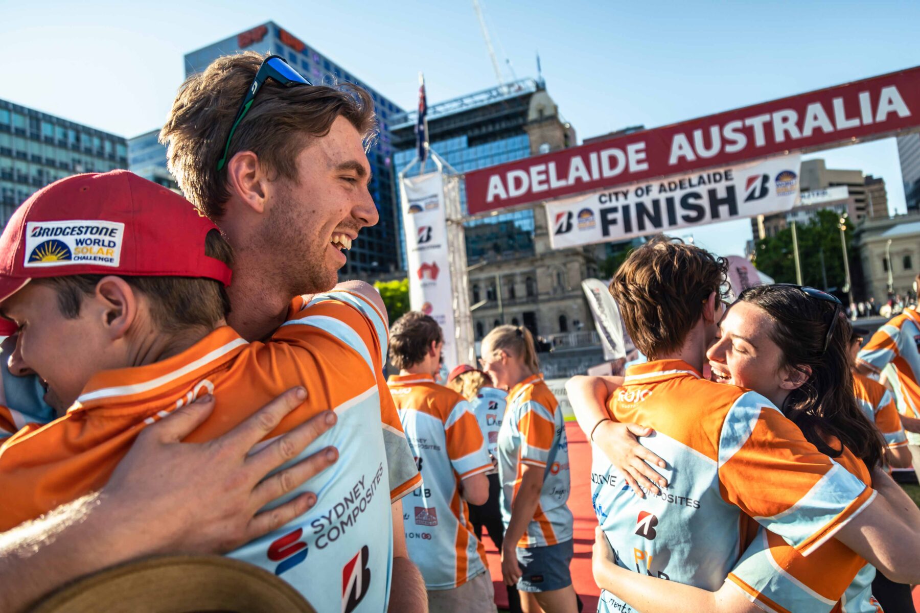 The ANU Solar Racing team, including team leader Isaac Martin (second from left), celebrating their official finish at Victoria Square in Adelaide