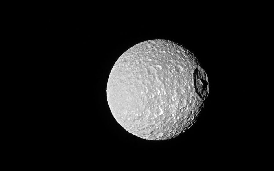 Shadows cast across Mimas' defining feature, Herschel Crater, provide an indication of the size of the crater's towering walls and central peak.