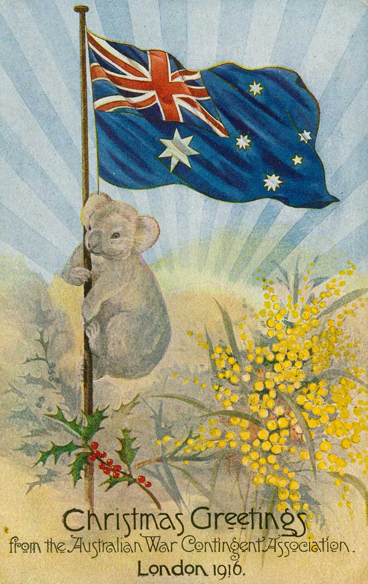 A postcard, showing a koala on the pole of the Australian flag, wattle and mistletoe, setting sun in background, with the words 'Christmas greetings from the Australian War Contingent Association, London 1916.'