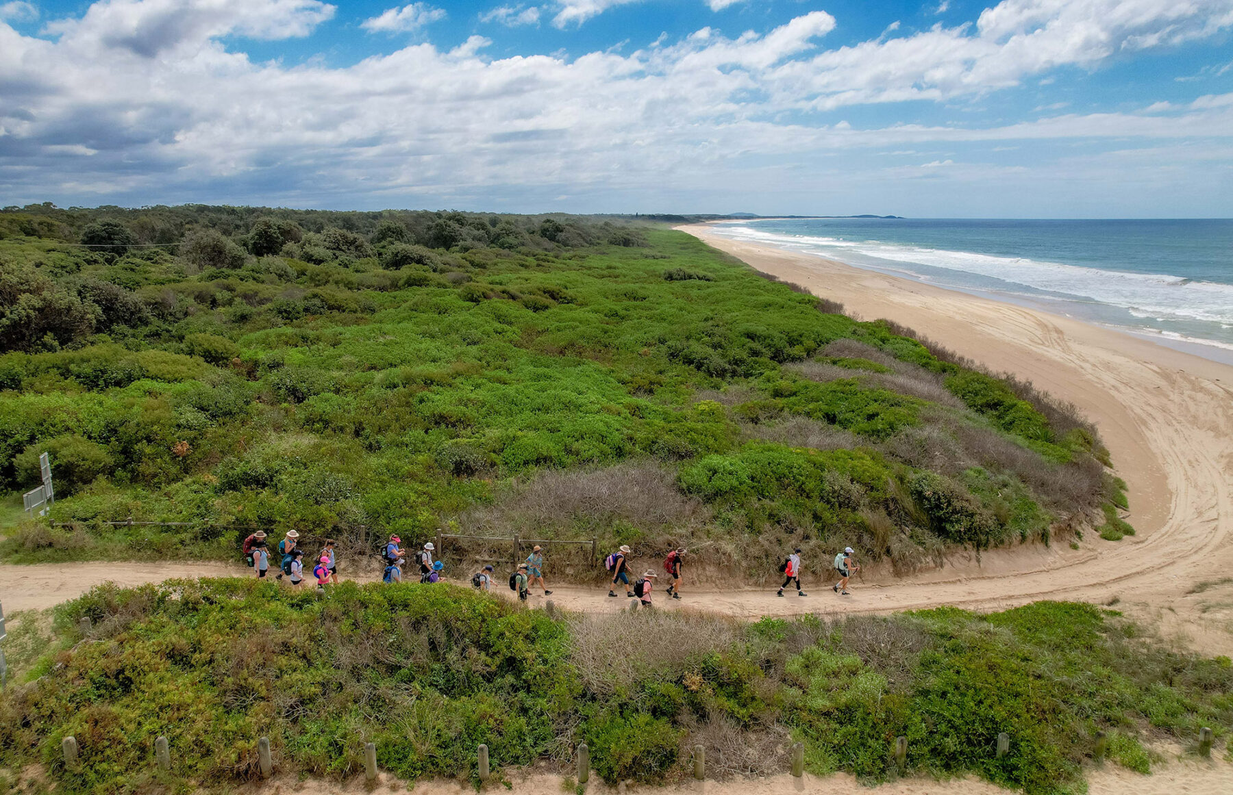 Hikers moving through the coastal hinterland toward one of the region’s spectacular beaches