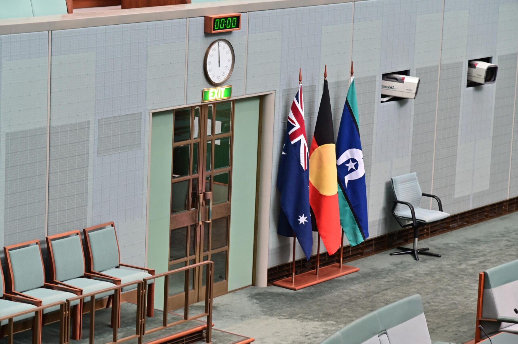 The three official flags of Australia stand in the House of Representatives inside Australia Parliament House.