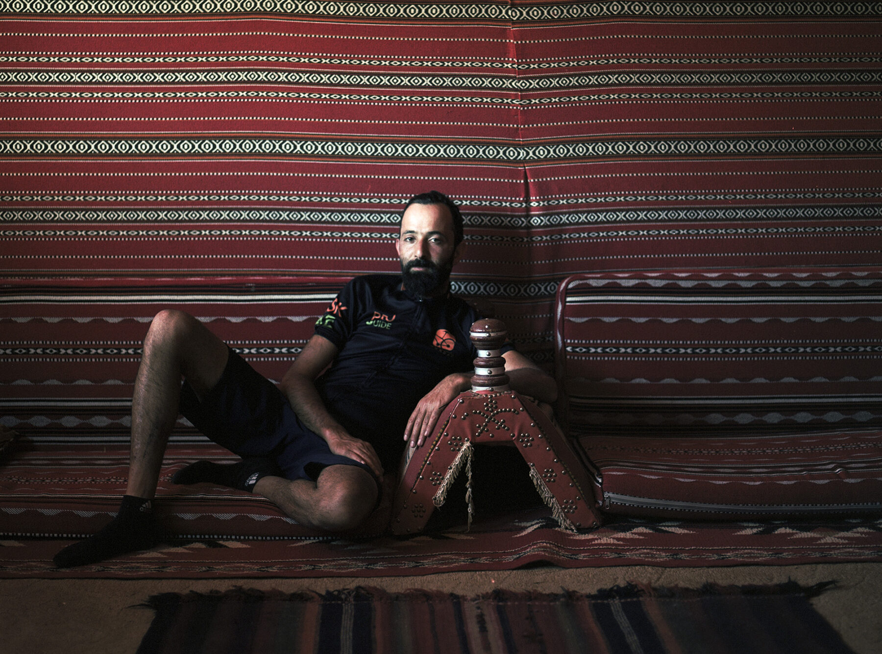 Sari Husseini, our perpetually cheerful and optimistic guide, rests in the shade of a Bedouin tent.
