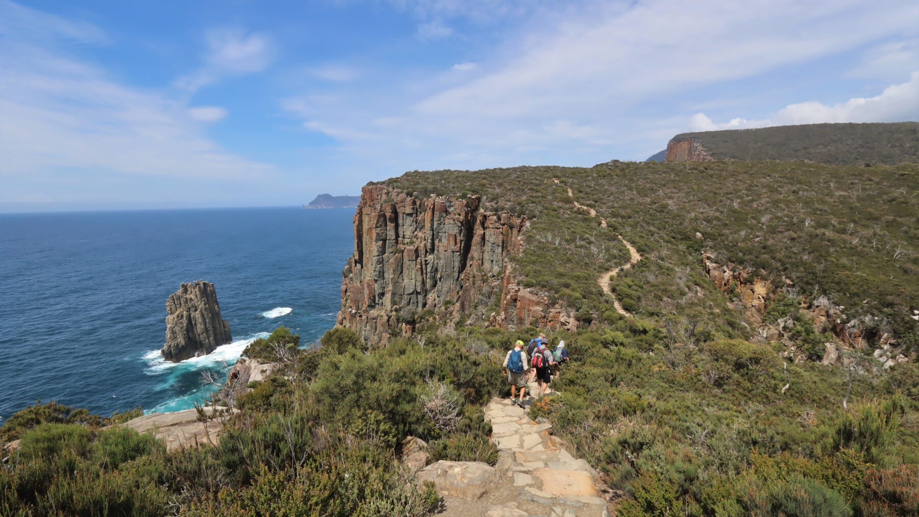 Hikers following a trail on the coast of Tasmania