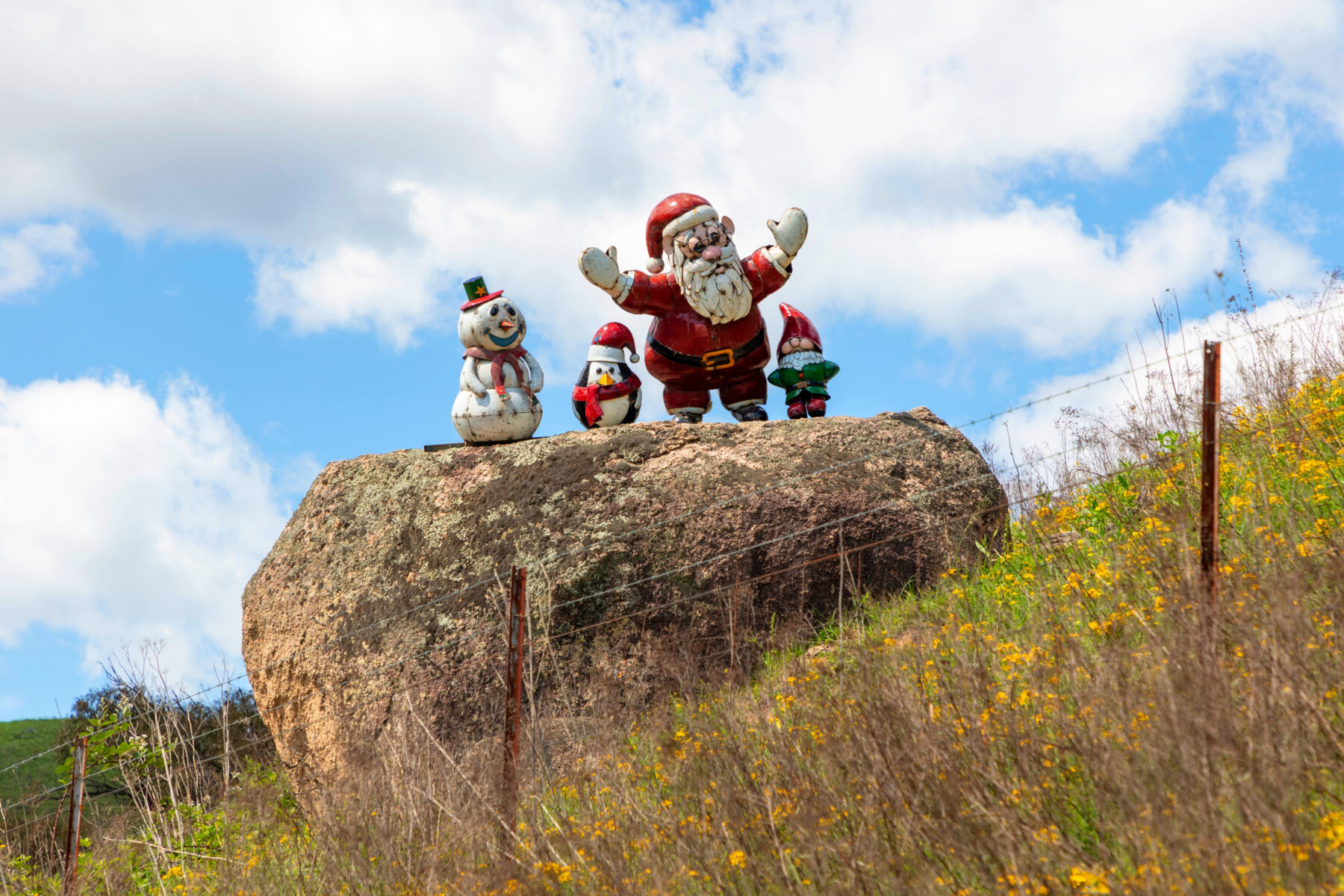 Christmas-themed statues on a large rock in bushland in regional Australi