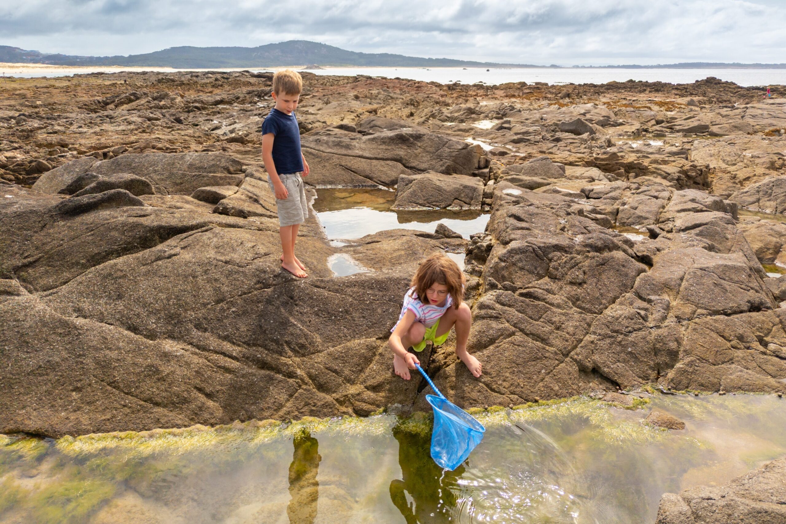 Children playing in rock pool