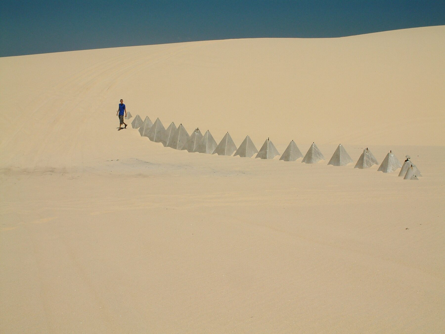Remnants of concrete tetrahedron (triangular pyramid) World War II tank traps on Stockton Beach
