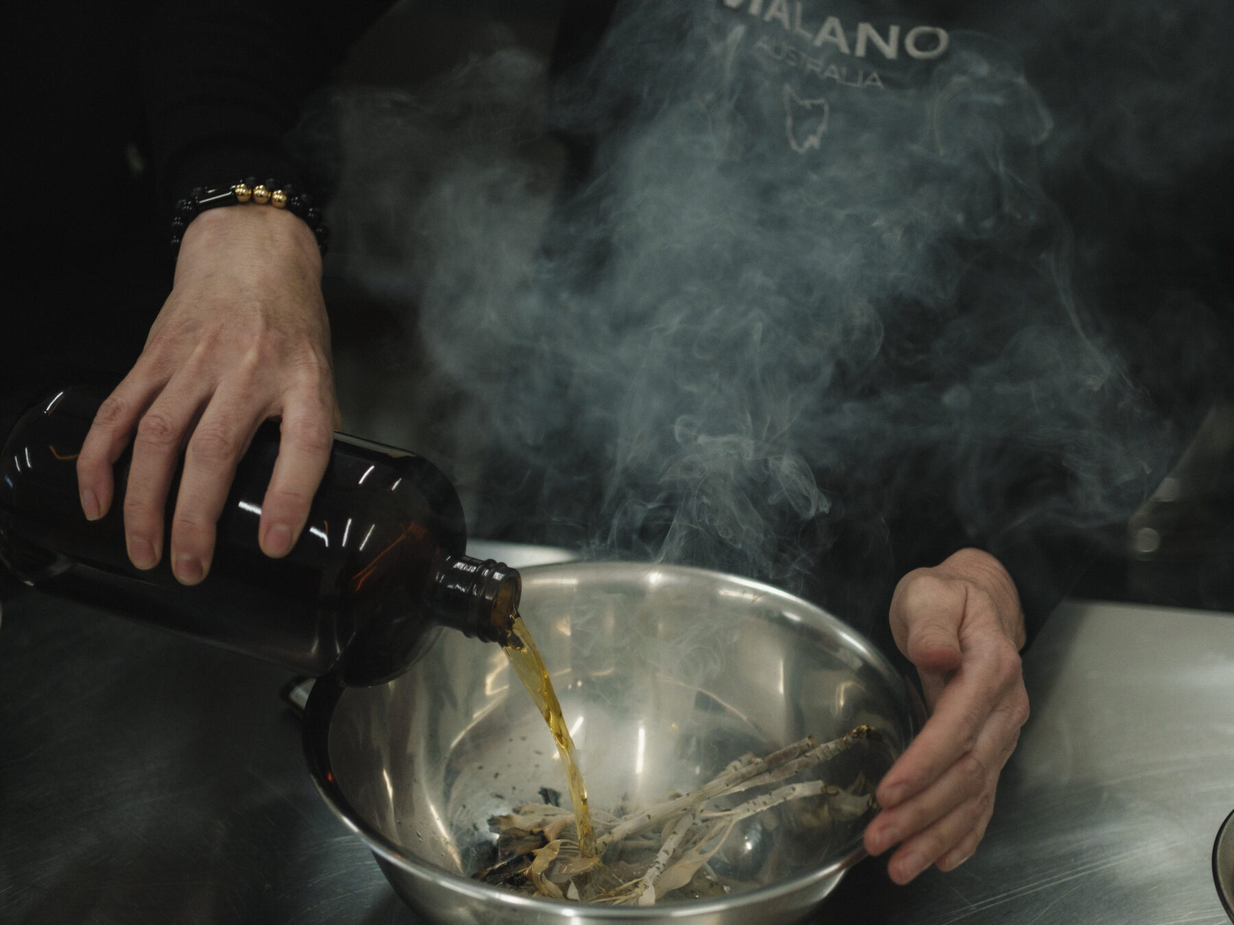 Smoke wafts from a bowl of burning broadleaf sage