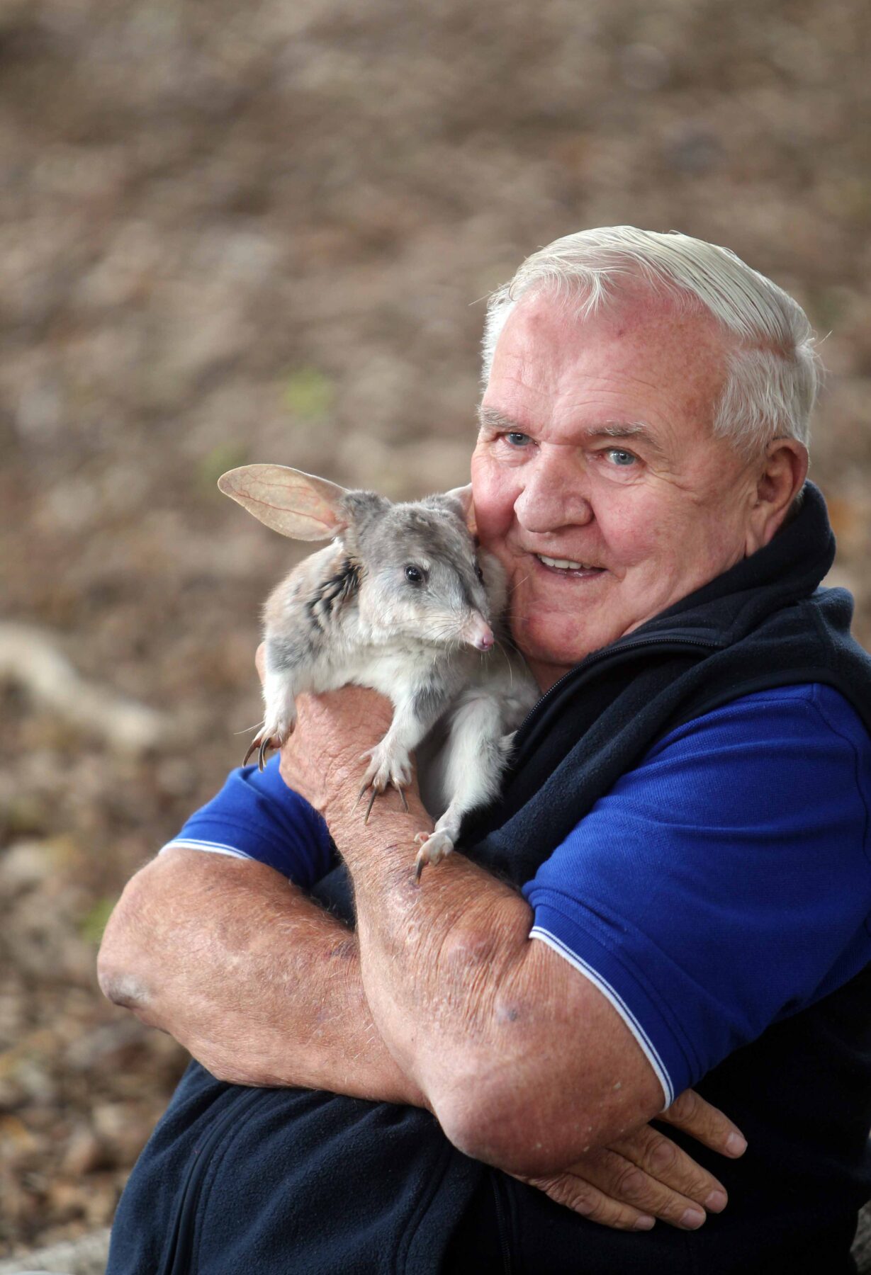 Frank Manthey, holding a bilby in his arms