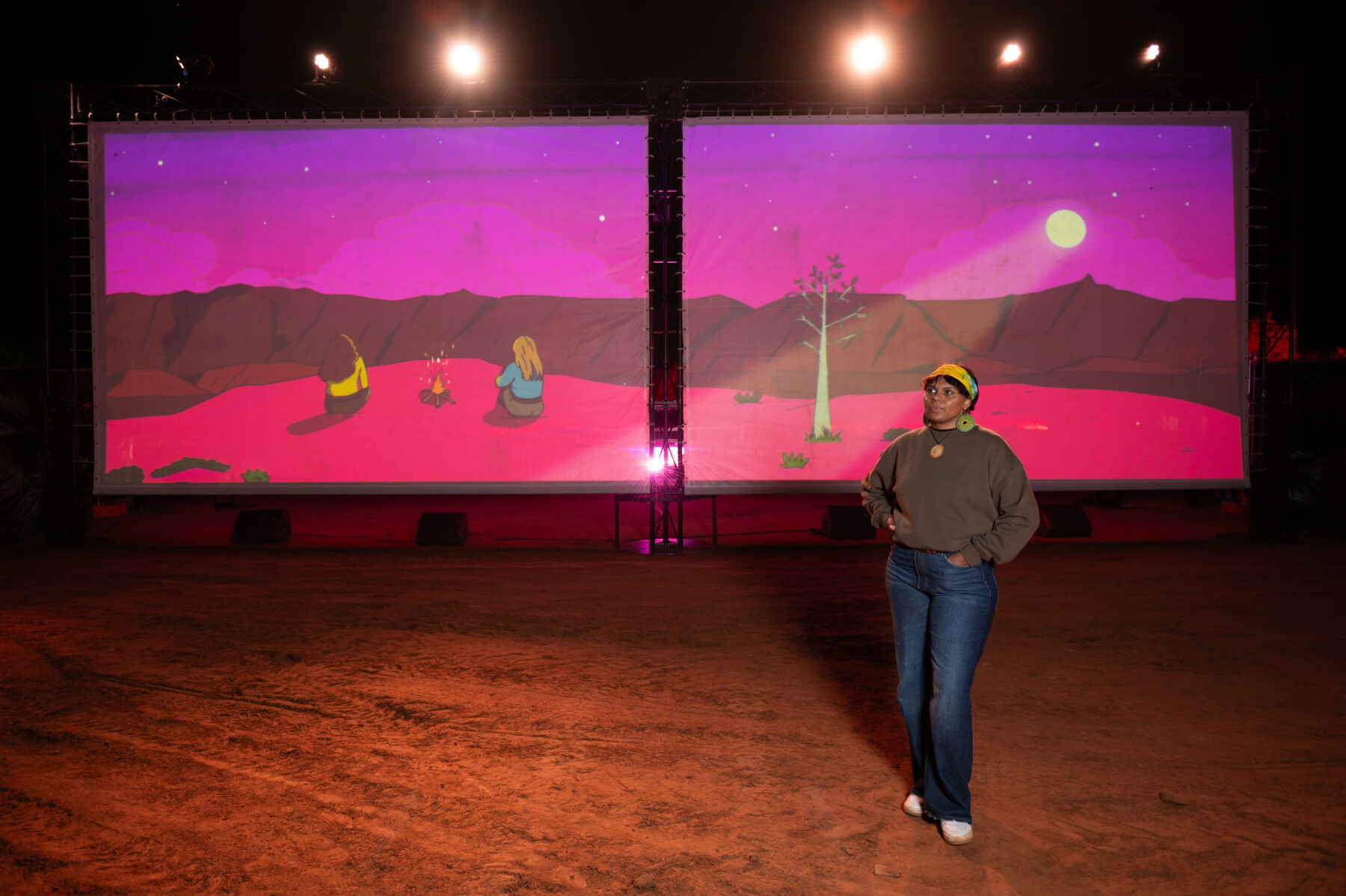 Molly Hunt in front of her artwork 'Three Generations of Station Women'