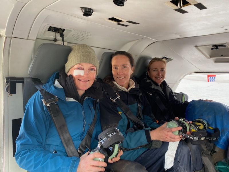 Anna Nicholas (left), with friends Claire Cook and Claire Hynes, sits on board a rescue helicopter after being airlifted from Tasmania’s remote South Coast Track
