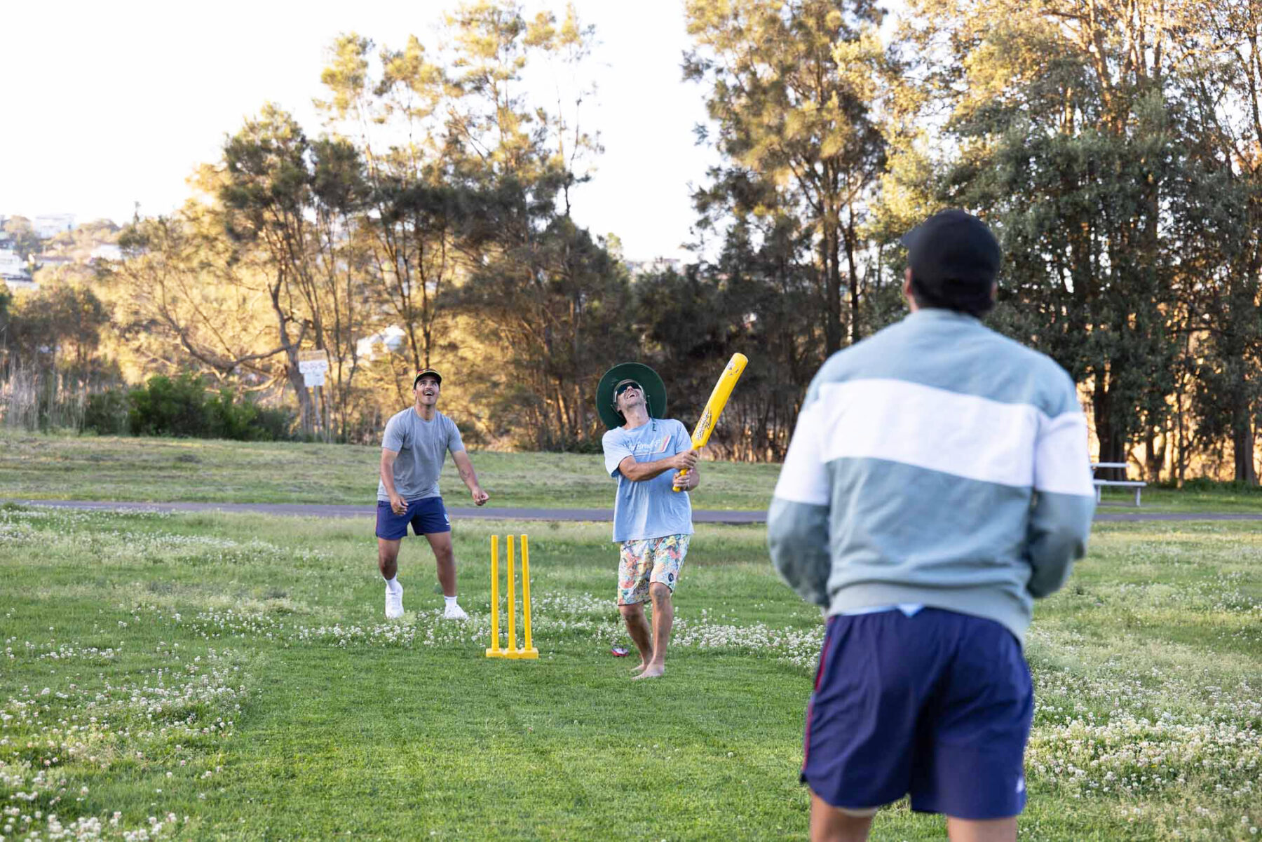 Ollie Davies keeps while his brother, Joel, and dad, Kev, face off on a freshly mowed patch of grass at Adams Street Reserve