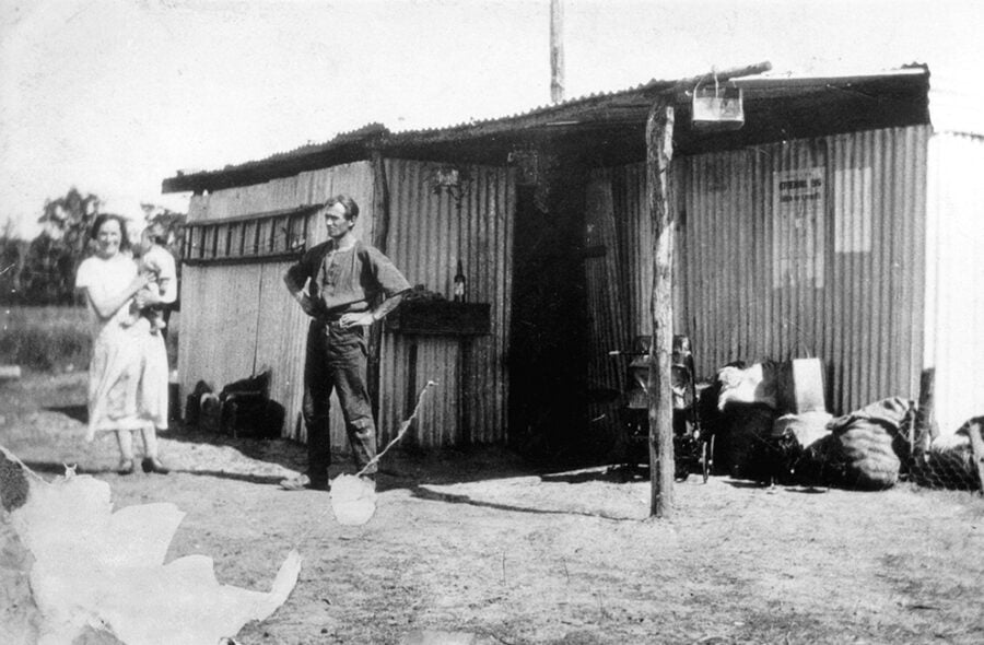 The Bashford family stand outside their makeshift home – a shack made of sheets of galvanised iron – in Northcliffe, circa 1925